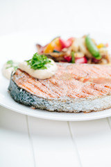 Grilled Salmon with Fresh vegetables on white background