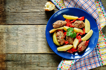 meat cutlets baked with potatoes, tomatoes and red pepper