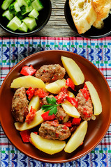 meat cutlets baked with potatoes, tomatoes and red pepper