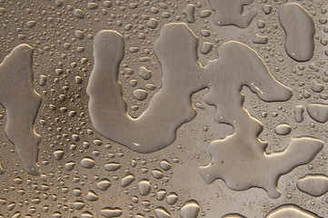 Fototapeta na wymiar waterdrops on brushed metal