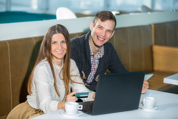 Happy couple with a credit card, selective focus