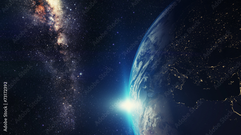 Wall mural blue sunrise, view of earth from space with milky way galaxy