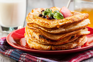 Pancakes with honey, fruit and glass of milk