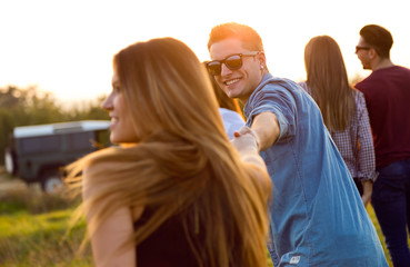 Portrait of group of friends having fun in field.