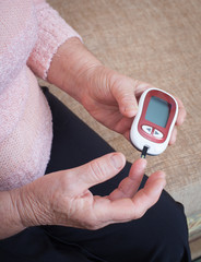 Woman testing for high blood sugar.