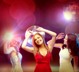 three smiling women dancing in the club