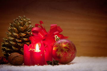 	Red christmas decoraion and advent candle  isolated on wooden b