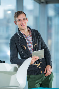 Young man using digital tablet and headphones