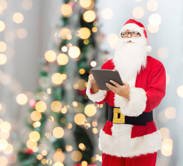 man in costume of santa claus with tablet pc