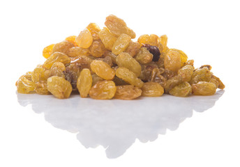 Golden colored dried raisin over white background