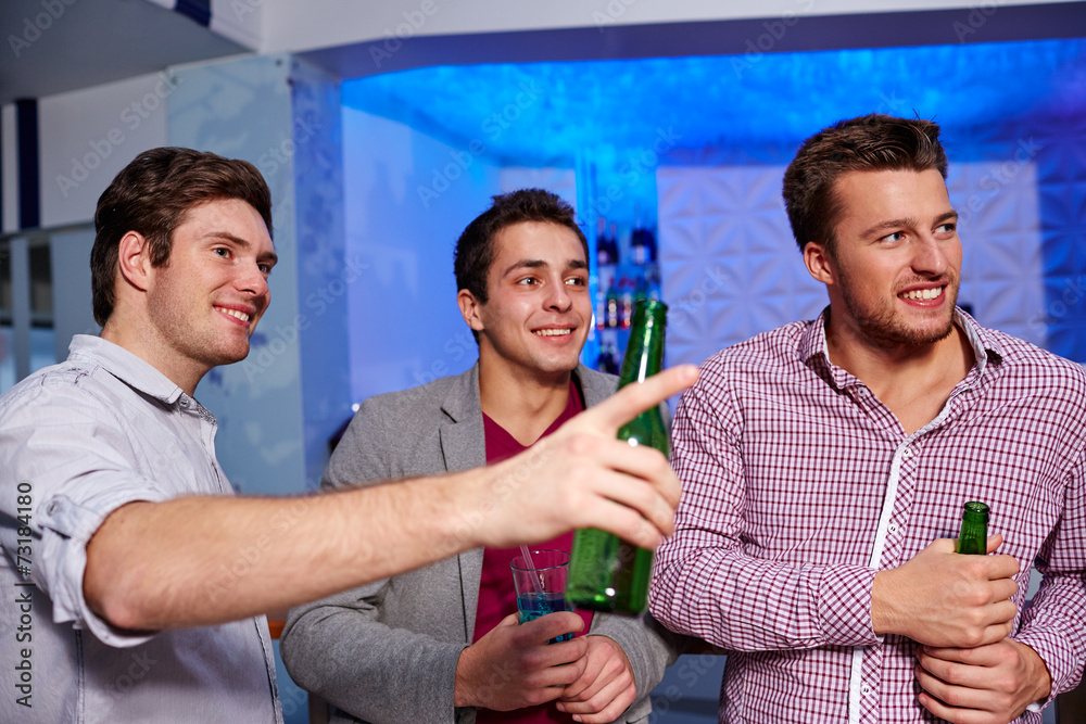 Poster group of male friends with beer in nightclub