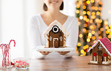 close up of woman showing gingerbread house