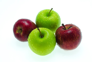 a red apple among green ones with drops of water