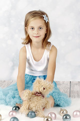 Beautiful girl with teddy bear and christmas balls