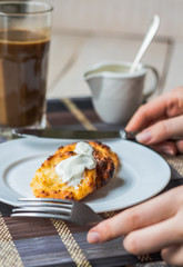 eat curd cheese pancakes with sour cream for breakfast, hands