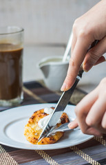 eat curd cheese pancakes with sour cream for breakfast, hands