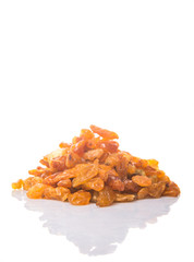 Dried orange colored raisin over white background