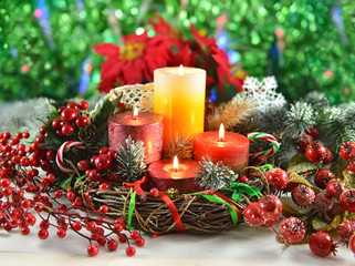 Christmas candles in wreath with decorations
