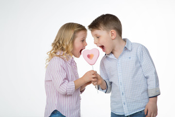 brother and sister eating lollipop