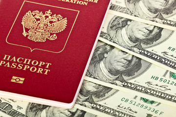 Naklejka premium Russian passport lies on US dollars