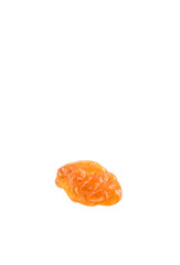 Dried orange colored raisin over white background