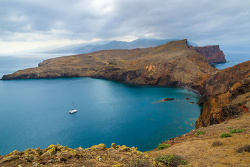Fototapeta premium Catamaran boat in ocean bay on coast of Madeira island, Portugal