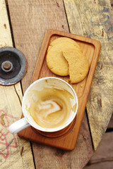 close up hot latte and cookie on wooden table