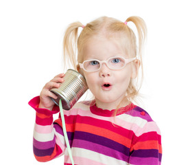 Funny child in eyeglasses using a can as a telephone isolated