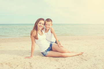 Mother and her son having fun on the beach