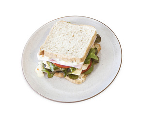 Ham sandwich on brown bread with tomatoes and lettuce