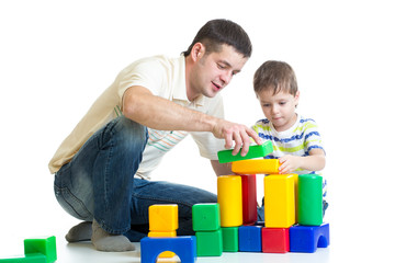 kid and his dad play with building blocks