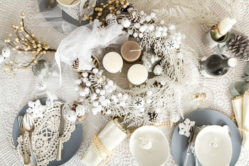 Fototapeta na wymiar Christmas Table Setting with traditional Holiday Decorations