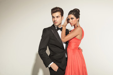 woman fixing her hair while her lover is looking away