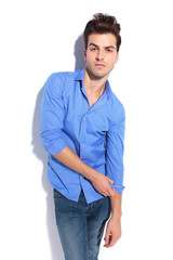 Fototapeta premium Attractive young fashion man pulling his sleeve.