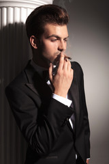 Fototapeta na wymiar handsome business man smoking a cigarette