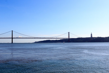 25 de Abril Bridge with Christ the King Statue in Lisbon