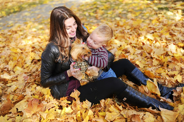 mother with the son is among autumn foliage