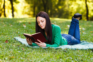 Woman reading book in park