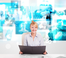Business person at desk with modern tech images at background