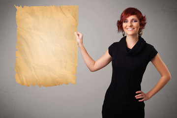 Young girl presenting old paper copy space