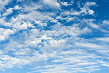 Cirrus and cumulus white clouds on the blue sky