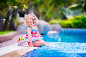 Little beautiful girl in a swimming pool