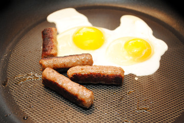 Cooking Two Sunny Side Up Eggs with Sausage