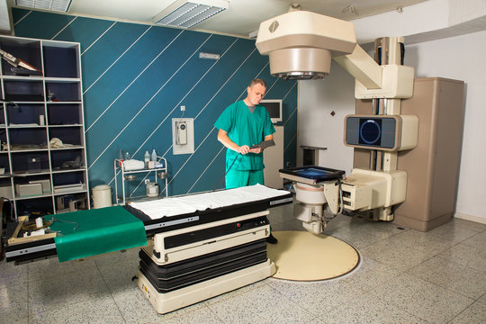 Radiotherapy room - Radiation therapy machine - Male radiologist
