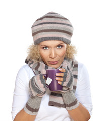 Woman in winter clothes drinking tea