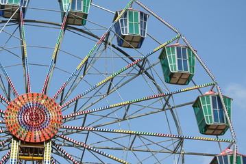 A colourful ferris wheel with blue sky background