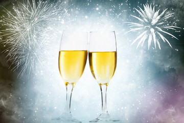Glasses with champagne against fireworks