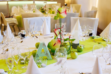 Elegant table set in white and green with apples for wedding par