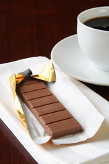 Milk chocolate with a cup of coffee