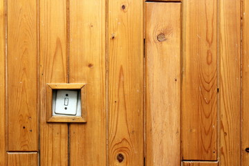 old electric switch on wooden wall